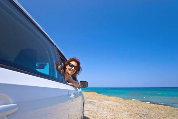 istock Happy woman travelling on a car . 813628478