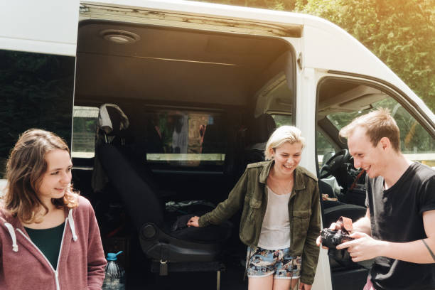 istock Friends talking near the van in forest 813634506