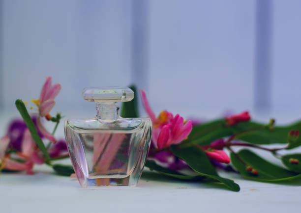 istock Perfume bottle with pink flower 813638102