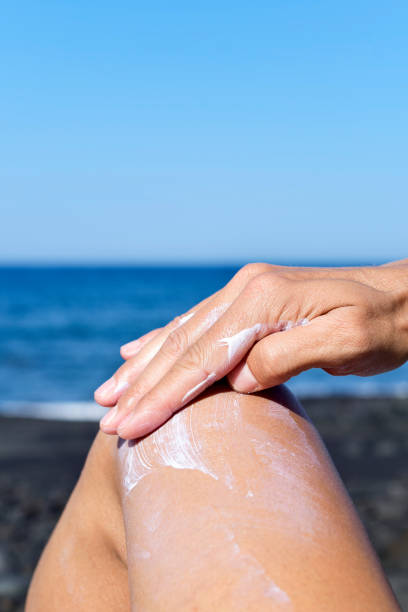 istock young man applying sunscreen to his leg 813641300