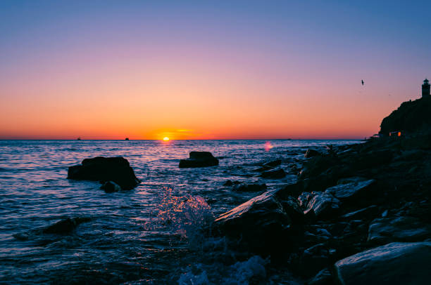 istock Bright sunset under the sea with waves splashes. 813645012