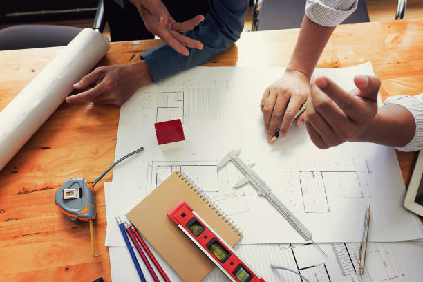 istock Team of engineers working together in a architect office. 813648536