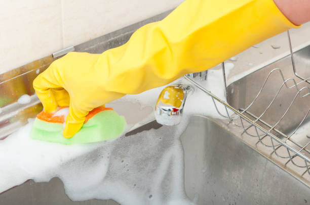 istock Woman doing chores in the kitchen at home 813654900