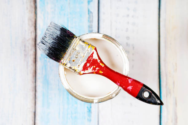 istock Full of blue paint tines and paint brushes on it 813655280
