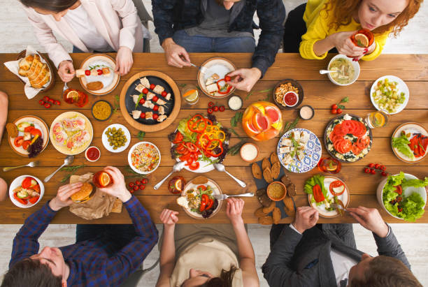 istock People eat healthy meals at served table dinner party 813655362