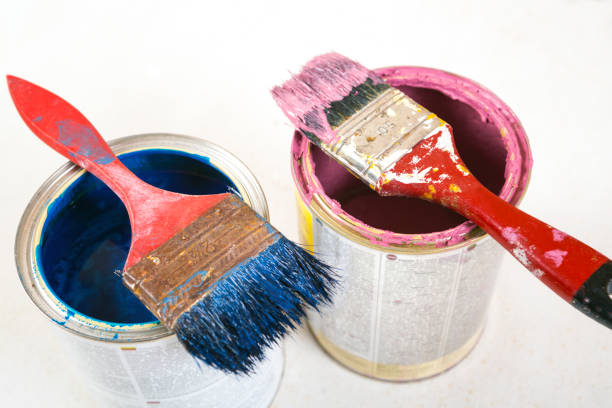 istock Full of blue paint tines and paint brushes on it 813655922