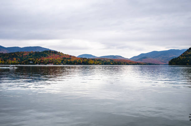 istock Beautiful Lake Surrounded by Forested Mountains on a Cloudy Autumn Day 813663038