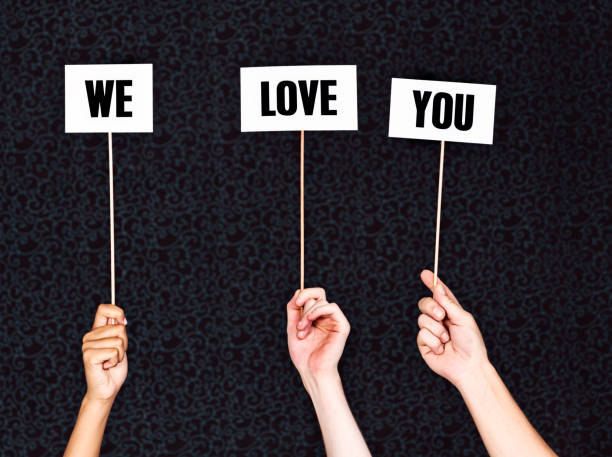 Hand-held signs read 