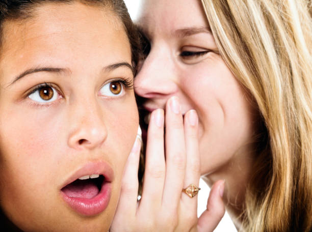 istock Two pretty young women sharing secrets and gossip 813681124