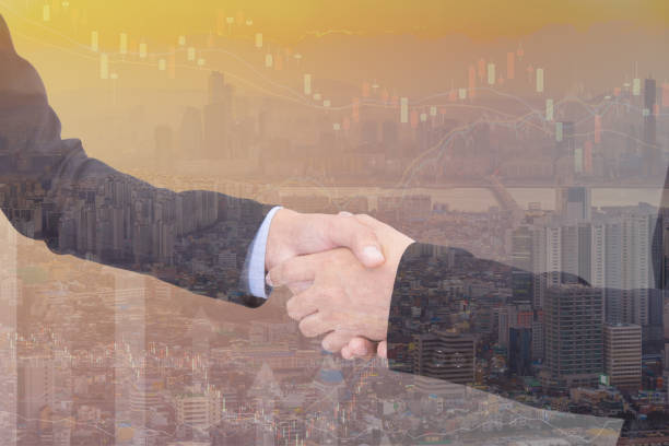 istock business handshake with city background, Double exposure style 813681208
