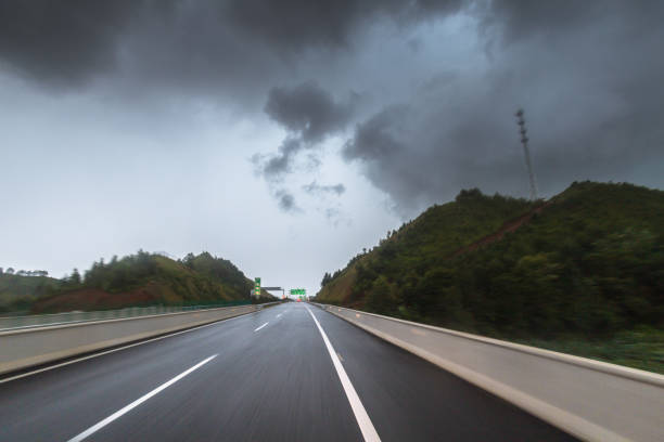 highway in motion blur under cloudy day before rainstorm in summer