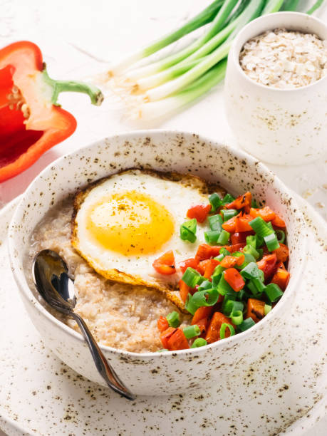 istock Savory oatmeal, served with vegetables and fried egg 813694694