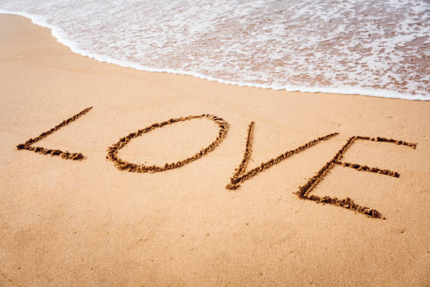 istock Love written in the sand 813694964