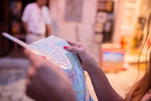 istock Woman tourist reading map 813697266