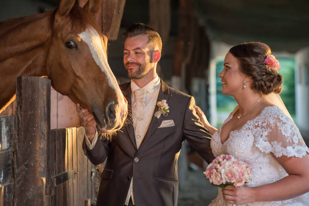 istock Beautiful young couple with horses 813697298