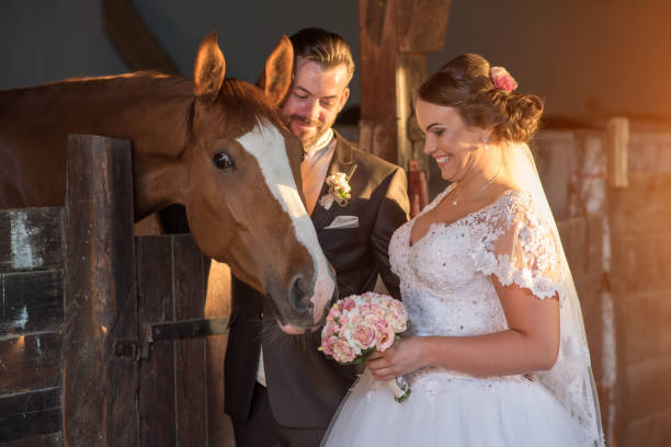 istock Beautiful young couple with horses 813697626