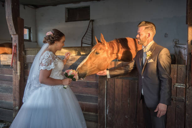 istock Beautiful young couple with horses 813697744