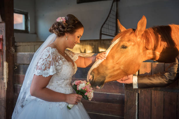 istock Beautiful young couple with horses 813697858