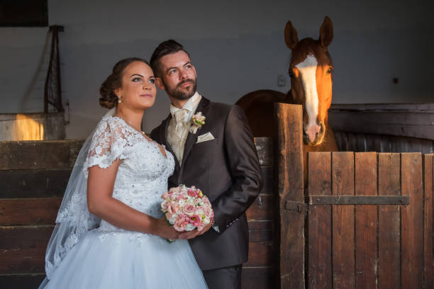 istock Beautiful young couple with horses 813698086