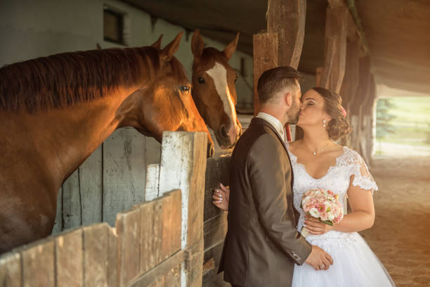 istock Beautiful young couple with horses 813698518