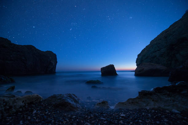 istock Scenic rocky seashore at sunset under the stars 813700674