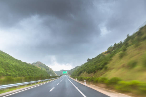 istock highway in motion blur under cloudy day before rainstorm in summer 813702904