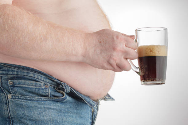 istock fat man with carbonated drink 813703400