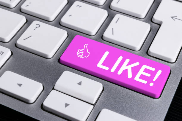 istock Close up view of a Computer notebook keyboard with one pink button with word LIKE, technology background, empty space for text 813708726