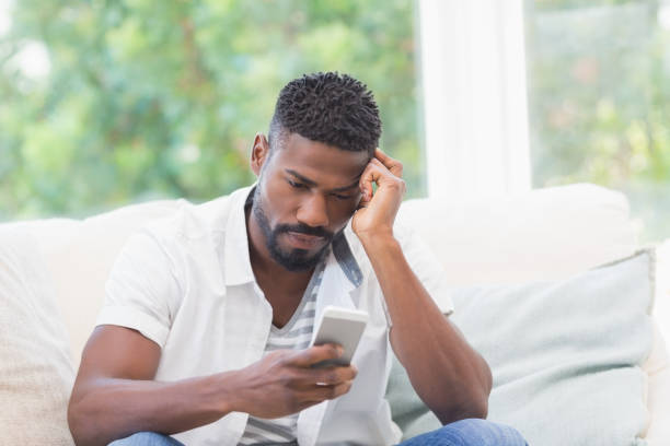 istock Worried man looking at his phone 813708980