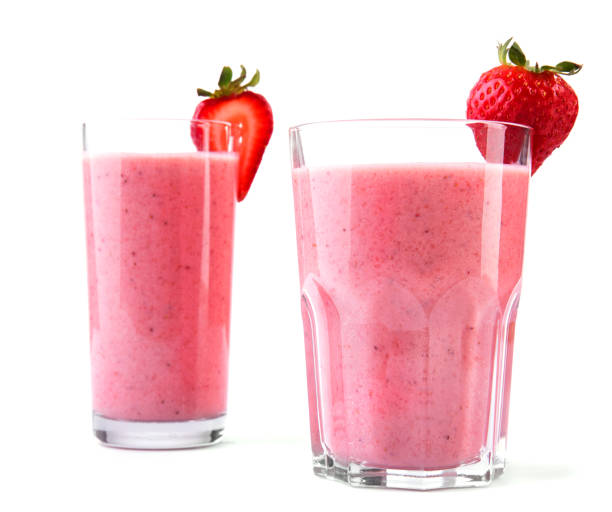 istock Two large and different glasses with cold and pink drinks made from juicy and fresh red strawberries and milk. Fruit cocktail with strawberries and milk. 813716884