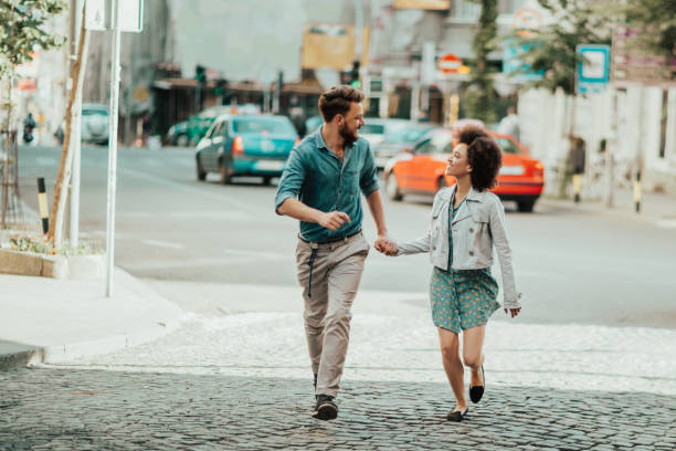 istock Couple holding hands is walking down the cobblestone 813719872
