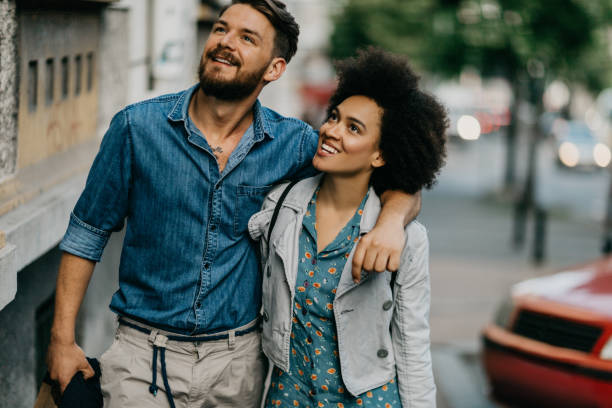 istock Couple looking at the rainbow in the sky 813724956