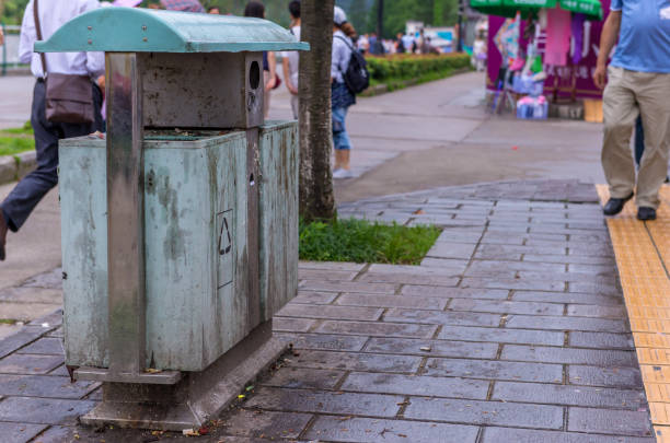 undamaged sports shoes lying on a garbage can on a street in the city center. abandoned textile shoes. shoes for further use for the poor and homeless.