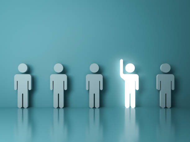 istock Stand out from the crowd and different concept , One glowing light man raising his hand among other people on light green background with reflections and shadows . 3D rendering 813729866