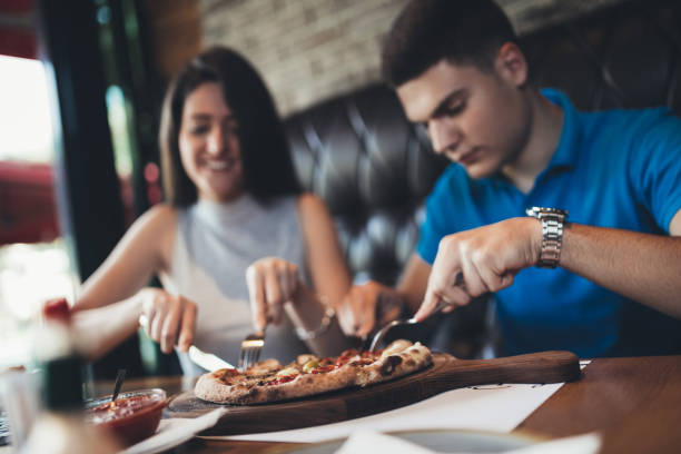 istock Young attractive couple enjoying pizza 813733310