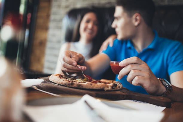 istock Young attractive couple enjoying pizza 813733336