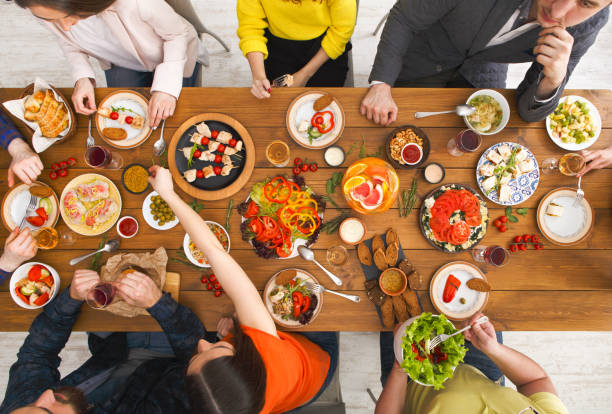 istock People eat healthy meals at served table dinner party 813739796