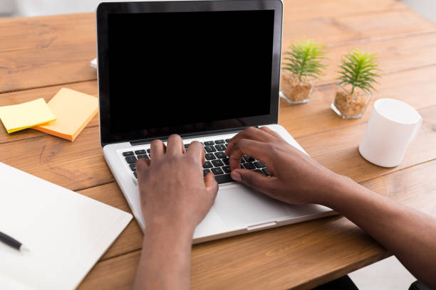 istock African-american businessman in office type on laptop 813739940