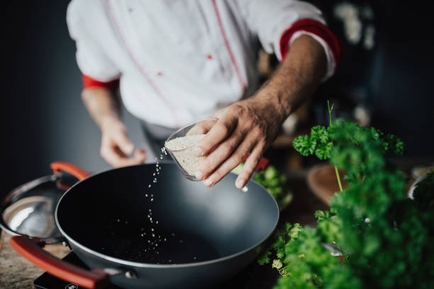 istock The cook pours sesame in the hot pan 813740846