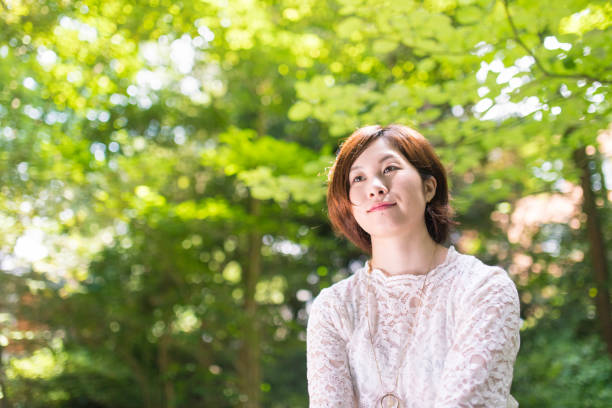 istock Beautiful woman in green forest 813743134