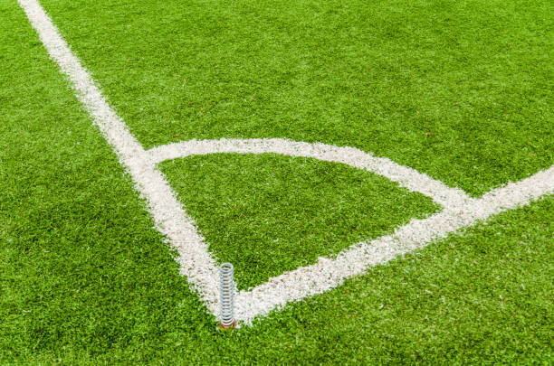 istock Soccer field corner line on green grass. 813746516