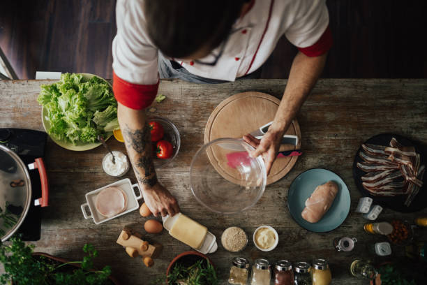 Top view at chef who starts to prepare a meal for dinner