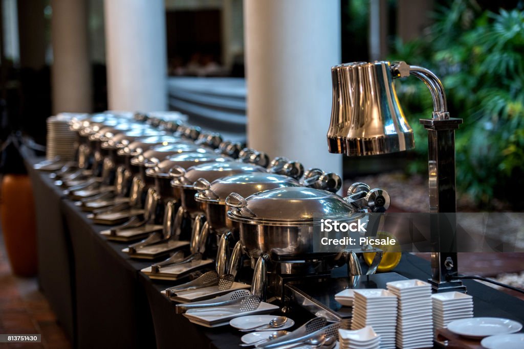 Buffet Table with Row of Food Service Steam Pans Selective focus at steam pans Archival Stock Photo