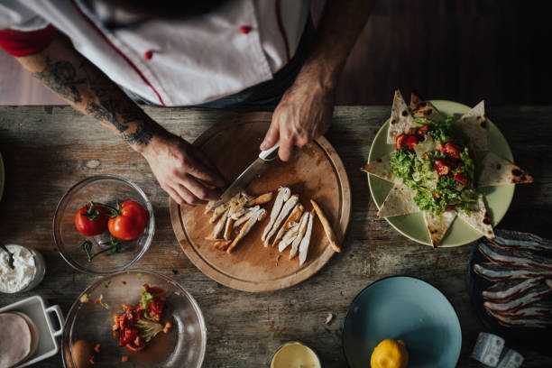 istock Top view at tattooed chef preparing Caesar's salad 813754394
