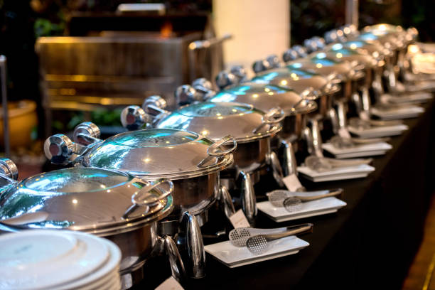 istock Buffet Table with Row of Food Service Steam Pans 813755244