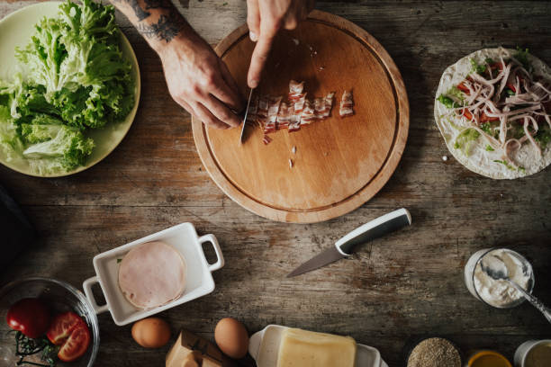 istock A person is chopping bacon for wrap sandwich 813755518