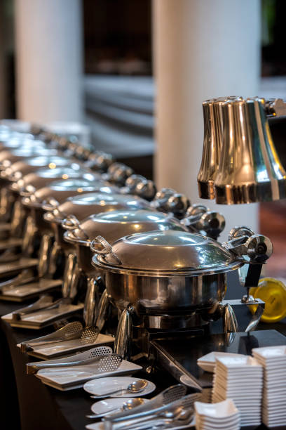 istock Buffet Table with Row of Food Service Steam Pans 813755772
