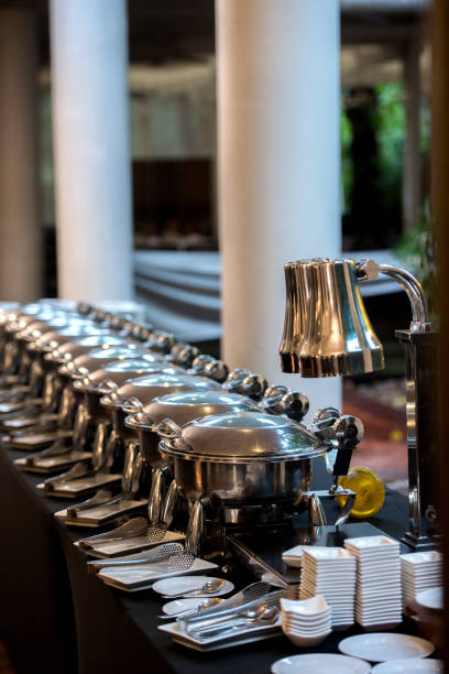 istock Buffet Table with Row of Food Service Steam Pans 813762902