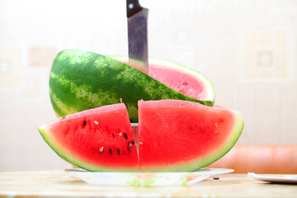 istock Cut watermelon with a knife on the table 813768758