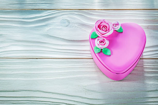istock Heart-shaped present box on wood board copy space celebrations c 813793880